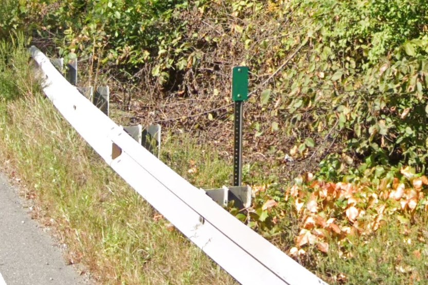 Green bollard at guardrail end